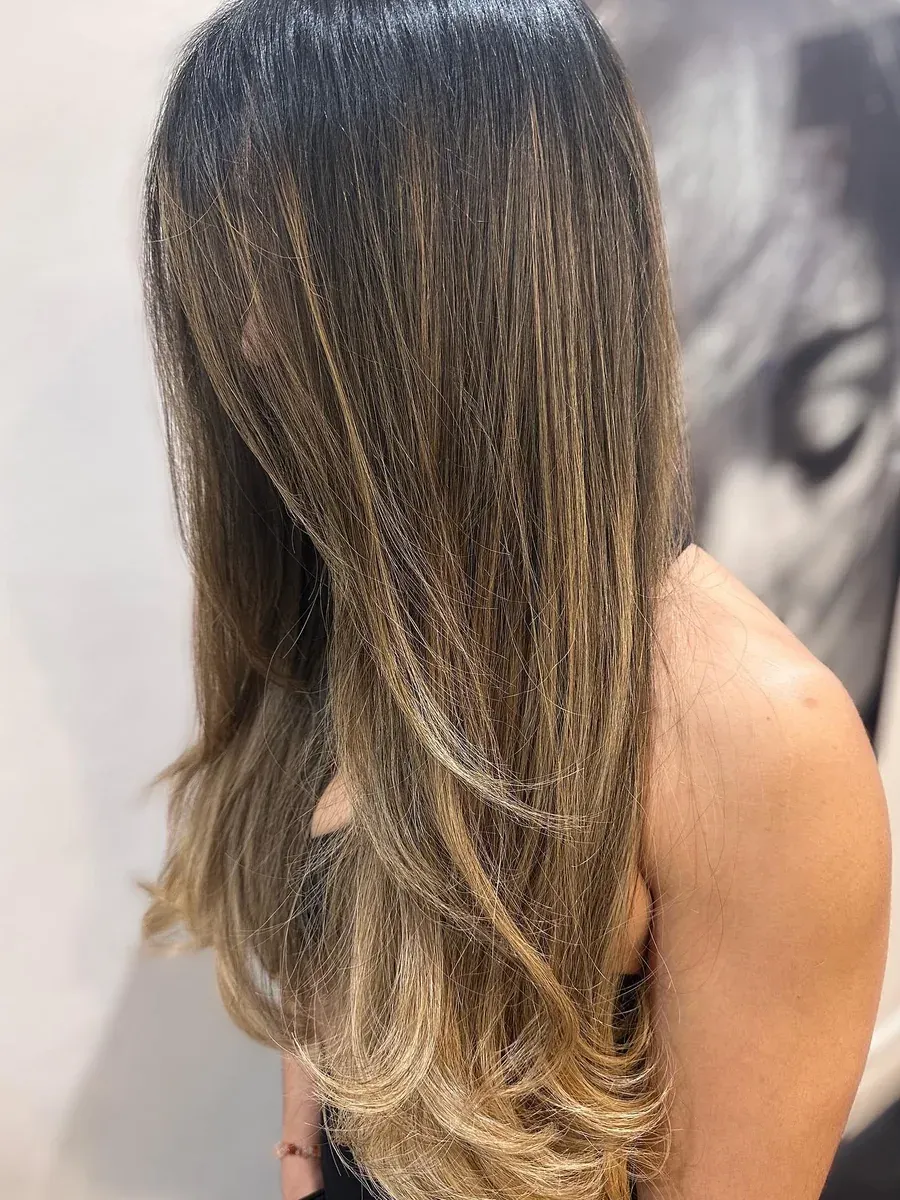 Long dark brunette with a soft bronde balayage through the ends, Rokk Ebony Malvern.