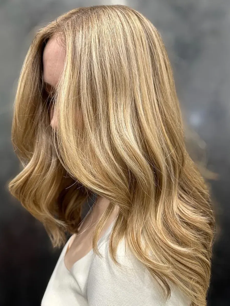 Long golden blonde with a soft wave finish, Rokk Ebony Malvern.