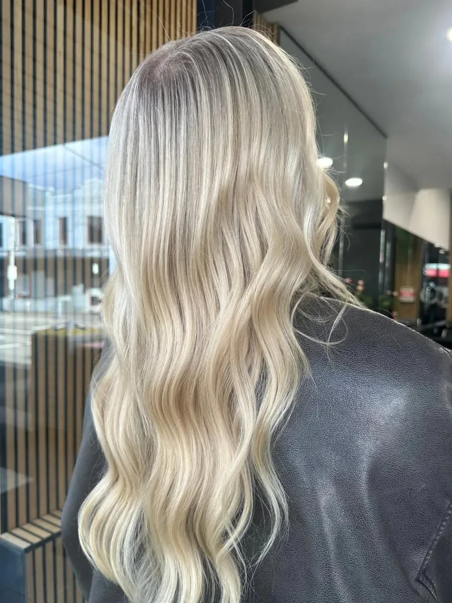 Long platinum blonde with a shadowed root, Rokk Ebony Malvern.